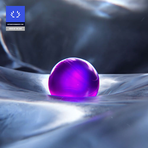 A purple ball sitting on top of a shiny surface